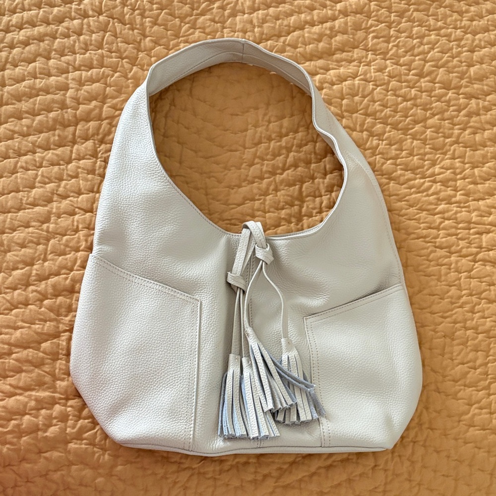 Laggo 
Elegant Cream Hobo Bag with Tassel Accents